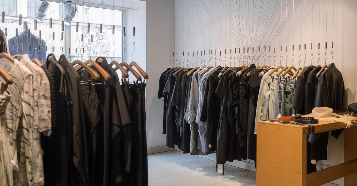 Modern clothing store showcasing a variety of garments on hangers.