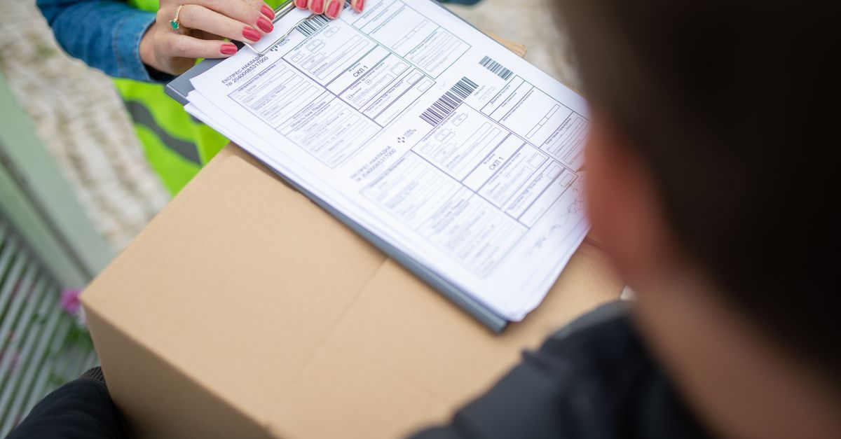Courier hands over a package for delivery with signing of receipt documents.